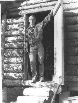 Keith McIntosh's photo of John 
Randolph in the doorway of the freshly built New Boys cabin